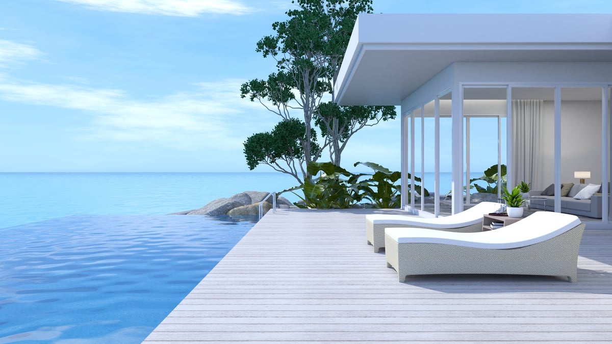 Sunbathing on the seaside terrace with swimming pool, sunny blue sea view