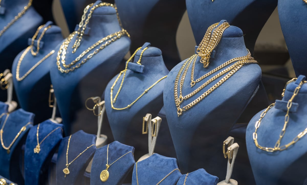 Luxurious display of elegant gold necklaces and jewelry in a high-end boutique window