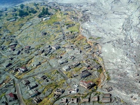 Aerial view of Plymouth, Montserrat's abandoned former capital, half-buried in grey volcanic ash from the Soufrière Hills volcano