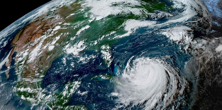 Satellite image of Hurricane Erin spinning over the Atlantic just north of the Caribbean islands in August 2025