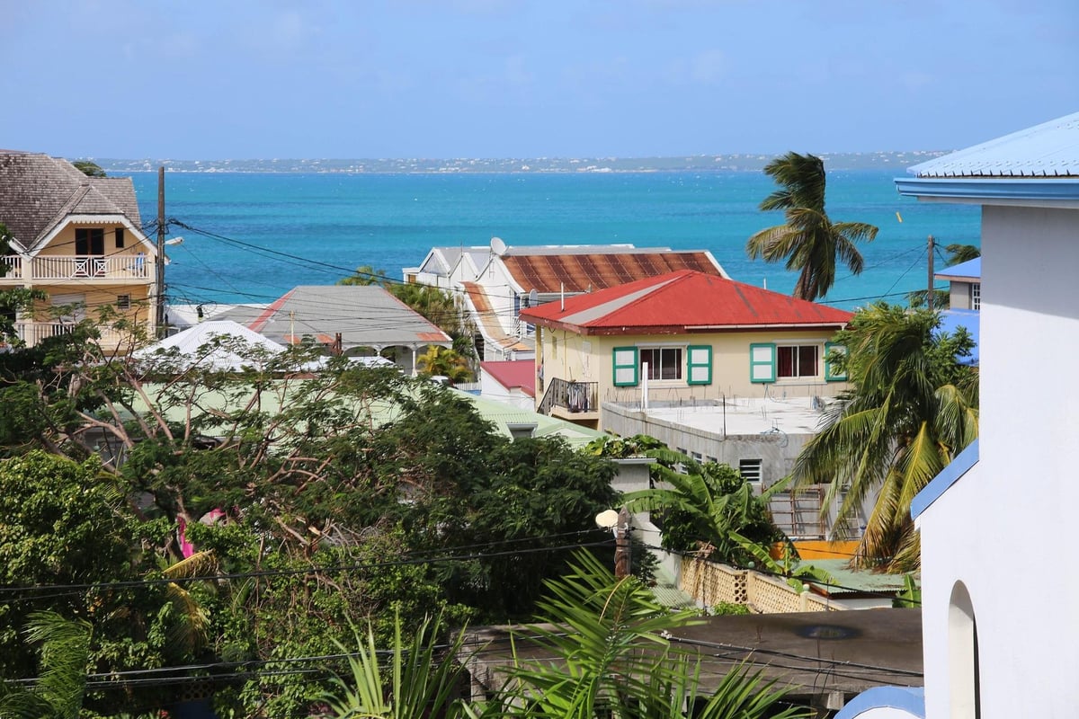 Colorful houses with red roofs stepping down to the sea in Grand Case, St. Martin