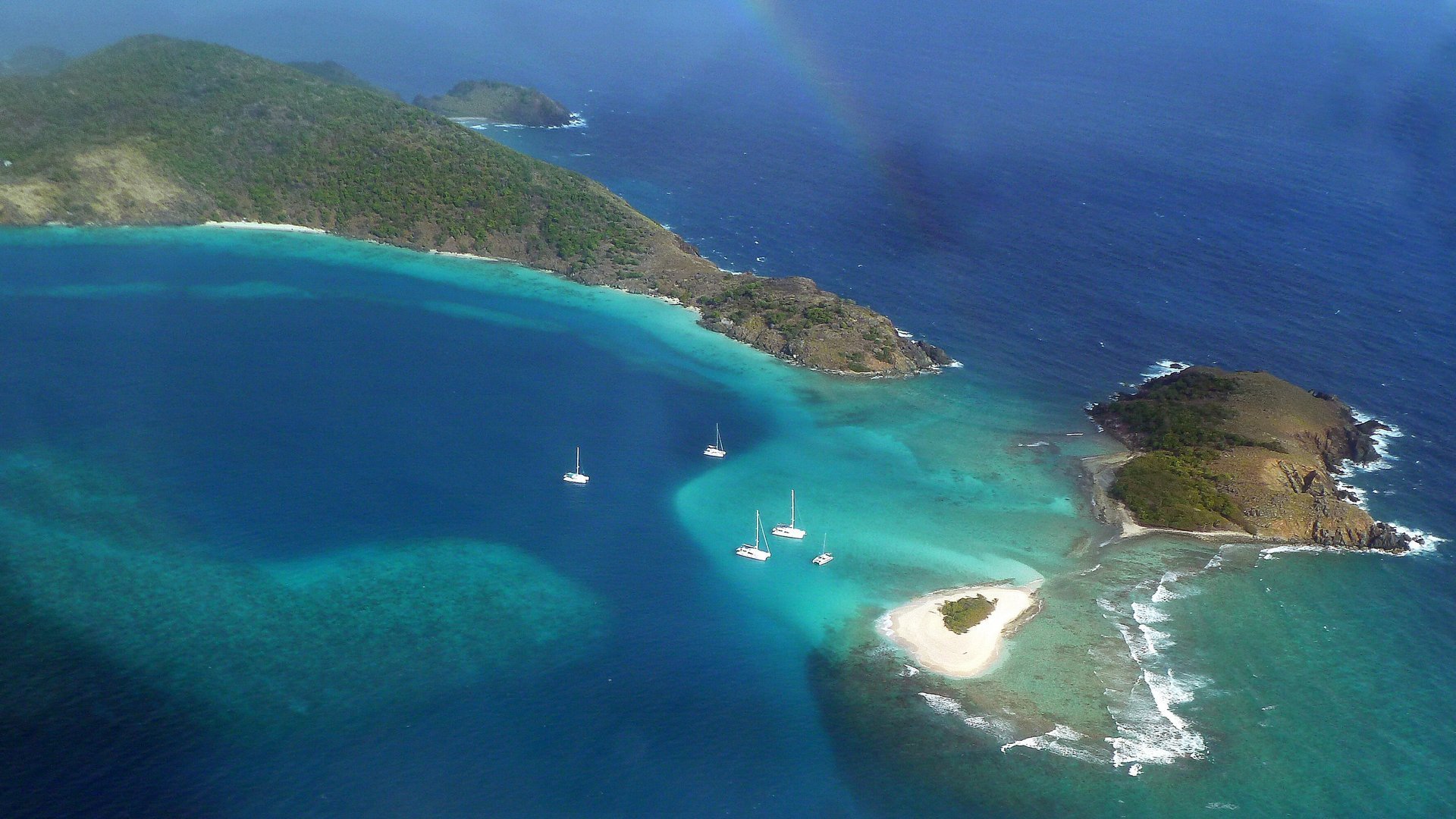 Aerial view of Little Jost Van Dyke, Green Cay and the tiny white islet of Sandy Spit surrounded by turquoise shallows, British Virgin Islands